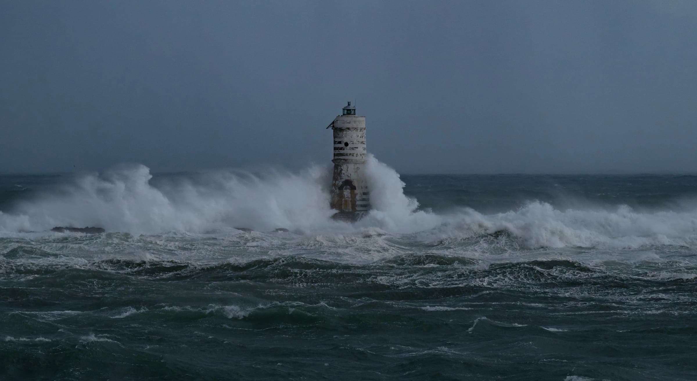 Phare battu par les vagues pendant une tempête.